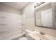 Bathroom with a shower-tub combo, sink vanity, and decorative mirror at 270 S Lasalle St, Indianapolis, IN 46201