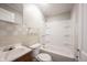 Bathroom with a shower-tub combo, wood-look vanity, and a mirrored medicine cabinet at 270 S Lasalle St, Indianapolis, IN 46201