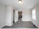 Bedroom with neutral walls and carpet, with a view into the hallway and kitchen at 270 S Lasalle St, Indianapolis, IN 46201