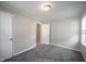 Bedroom with neutral walls, carpet, and a window offering natural light at 270 S Lasalle St, Indianapolis, IN 46201