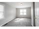 Cozy bedroom featuring neutral walls, carpeting, and plenty of natural light at 270 S Lasalle St, Indianapolis, IN 46201