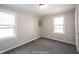 Bedroom featuring neutral walls, carpet, and two windows providing natural light at 270 S Lasalle St, Indianapolis, IN 46201