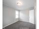 Bedroom featuring neutral walls, carpet, and a window offering natural light at 270 S Lasalle St, Indianapolis, IN 46201