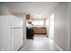 Functional kitchen featuring wood cabinets and neutral countertops, with view to other living space at 270 S Lasalle St, Indianapolis, IN 46201