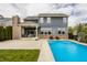 Spacious backyard with in-ground pool, covered patio, and ample seating for outdoor entertaining at 2785 W High Grove Cir, Zionsville, IN 46077