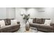 Finished basement boasts a sitting area with plush sofas, neutral carpet flooring, and modern décor at 2785 W High Grove Cir, Zionsville, IN 46077