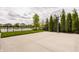 Full basketball court with lush landscaping, a scenic pond, and neighborhood homes at 2785 W High Grove Cir, Zionsville, IN 46077
