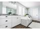 Bright bathroom featuring double vanity, soaking tub with tile surround, and wood-look flooring at 2785 W High Grove Cir, Zionsville, IN 46077
