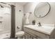 Elegant bathroom with a modern vanity, framed mirror, and a shower stall, creating a serene and functional space at 2785 W High Grove Cir, Zionsville, IN 46077
