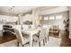 Open concept dining area flows from kitchen to living room with modern decor and ample seating space at 2785 W High Grove Cir, Zionsville, IN 46077