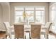 Bright dining room with seating for six, large windows, and views of the front yard and the neighborhood at 2785 W High Grove Cir, Zionsville, IN 46077