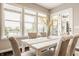 Elegant dining room with seating for six, large windows, and access to an outdoor patio or porch at 2785 W High Grove Cir, Zionsville, IN 46077