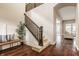 Inviting foyer with hardwood floors, a staircase, and a view into the living spaces at 2785 W High Grove Cir, Zionsville, IN 46077
