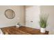 Well lit hallway with a wooden desk, circular mirror, and decorations, perfect for entry or a study nook at 2785 W High Grove Cir, Zionsville, IN 46077
