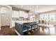 Kitchen with modern white cabinets, a large island with seating, pendant lights and eat-in dining area at 2785 W High Grove Cir, Zionsville, IN 46077