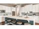 Kitchen boasts a large island, stainless steel appliances, stylish pendant lights, and modern backsplash at 2785 W High Grove Cir, Zionsville, IN 46077