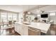 Bright kitchen features a large island with seating, stainless steel appliances, and an adjacent dining area at 2785 W High Grove Cir, Zionsville, IN 46077