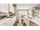Modern kitchen design featuring stainless steel appliances, white cabinets, and a view of the dining area at 2785 W High Grove Cir, Zionsville, IN 46077