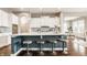 Bright kitchen features a large island with seating, white cabinets, and modern pendant lighting at 2785 W High Grove Cir, Zionsville, IN 46077