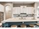 Modern kitchen with a large island, stainless steel appliances, and white cabinets providing an elegant design at 2785 W High Grove Cir, Zionsville, IN 46077