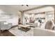 Bright and spacious living room open to the kitchen, featuring neutral tones and hardwood floors at 2785 W High Grove Cir, Zionsville, IN 46077