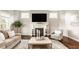 Inviting living room with a cozy fireplace, large windows, and stylish decor at 2785 W High Grove Cir, Zionsville, IN 46077
