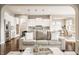 Stylish open concept living room with hardwood floors, a cozy seating arrangement, and a view into the kitchen at 2785 W High Grove Cir, Zionsville, IN 46077