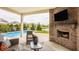 Enjoy this outdoor living area with brick fireplace overlooking the pool and beautiful backyard at 2785 W High Grove Cir, Zionsville, IN 46077