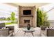 Relaxing covered patio with brick fireplace, outdoor seating, and serene backyard lake view at 2785 W High Grove Cir, Zionsville, IN 46077