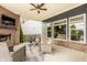 Covered patio with a brick fireplace, outdoor seating, ceiling fan, and relaxing atmosphere at 2785 W High Grove Cir, Zionsville, IN 46077