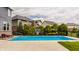 Sparkling in-ground pool and lounge area with lush landscaping, a basketball court, and nearby homes at 2785 W High Grove Cir, Zionsville, IN 46077