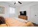 Well-lit bedroom with hardwood floors, soft bedding, and large window at 3134 Orchard Ave, Indianapolis, IN 46218