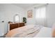 Well-lit bedroom featuring a large window, comfortable bedding, and hardwood floors at 3134 Orchard Ave, Indianapolis, IN 46218