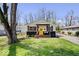 Charming single-story home with a bright yellow front door, nice yard, and inviting front porch at 3134 Orchard Ave, Indianapolis, IN 46218