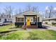 Charming home featuring a bright yellow door, inviting front porch, and fresh landscaping at 3134 Orchard Ave, Indianapolis, IN 46218