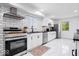 Bright kitchen featuring white cabinets, subway tile backsplash, and modern stainless steel appliances at 3134 Orchard Ave, Indianapolis, IN 46218