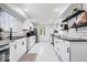 Modern kitchen featuring sleek white cabinets, subway tile backsplash, and stainless steel appliances at 3134 Orchard Ave, Indianapolis, IN 46218