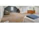 Finished attic space with plush carpeting, modern furniture, and ample natural light from windows at 3221 Washington St, Columbus, IN 47203