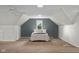 Finished attic bedroom features carpeted floors, sloped ceilings, and a cozy atmosphere at 3221 Washington St, Columbus, IN 47203