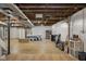 Open unfinished basement space provides ample storage with an exposed ceiling and duct work at 3221 Washington St, Columbus, IN 47203