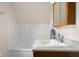 Bright bathroom features a bathtub with white tile surround and vanity with a mirrored medicine cabinet at 3221 Washington St, Columbus, IN 47203