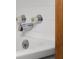 Close-up of the bathtub faucet and controls with decorative crystal handles and white tile surround at 3221 Washington St, Columbus, IN 47203