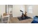 Bedroom featuring a stationary bicycle for exercise, and light-colored walls and flooring at 3221 Washington St, Columbus, IN 47203