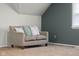 Comfortable couch with decorative pillows situated in a cozy room with neutral carpet and stylish blue walls at 3221 Washington St, Columbus, IN 47203