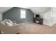 Cozy bedroom featuring neutral carpet, a comfortable couch and a mounted television on a wooden stand at 3221 Washington St, Columbus, IN 47203