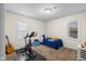 Bedroom includes a stationary bicycle, guitar, and a comfortable bed for a relaxing retreat at 3221 Washington St, Columbus, IN 47203