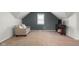 Cozy bedroom featuring neutral carpet, a comfortable couch and a mounted television on a wooden stand at 3221 Washington St, Columbus, IN 47203