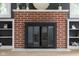Detailed view of the living room's charming fireplace, featuring a brick surround and built-in shelving at 3221 Washington St, Columbus, IN 47203