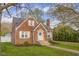 Quaint brick residence boasts a tidy lawn and a welcoming pathway to the entrance at 3221 Washington St, Columbus, IN 47203