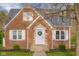 A brick home showcasing a classic facade, complemented by a decorative front door at 3221 Washington St, Columbus, IN 47203